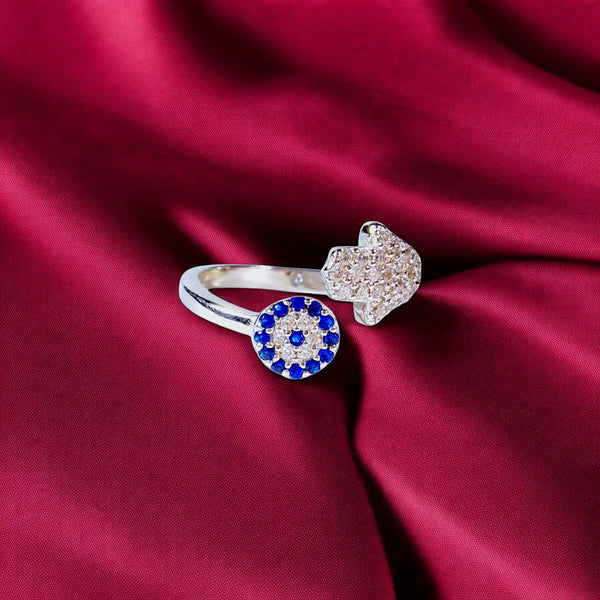 925 sterling silver ring with a blue sapphire halo design and pave crystals for women in colored background 